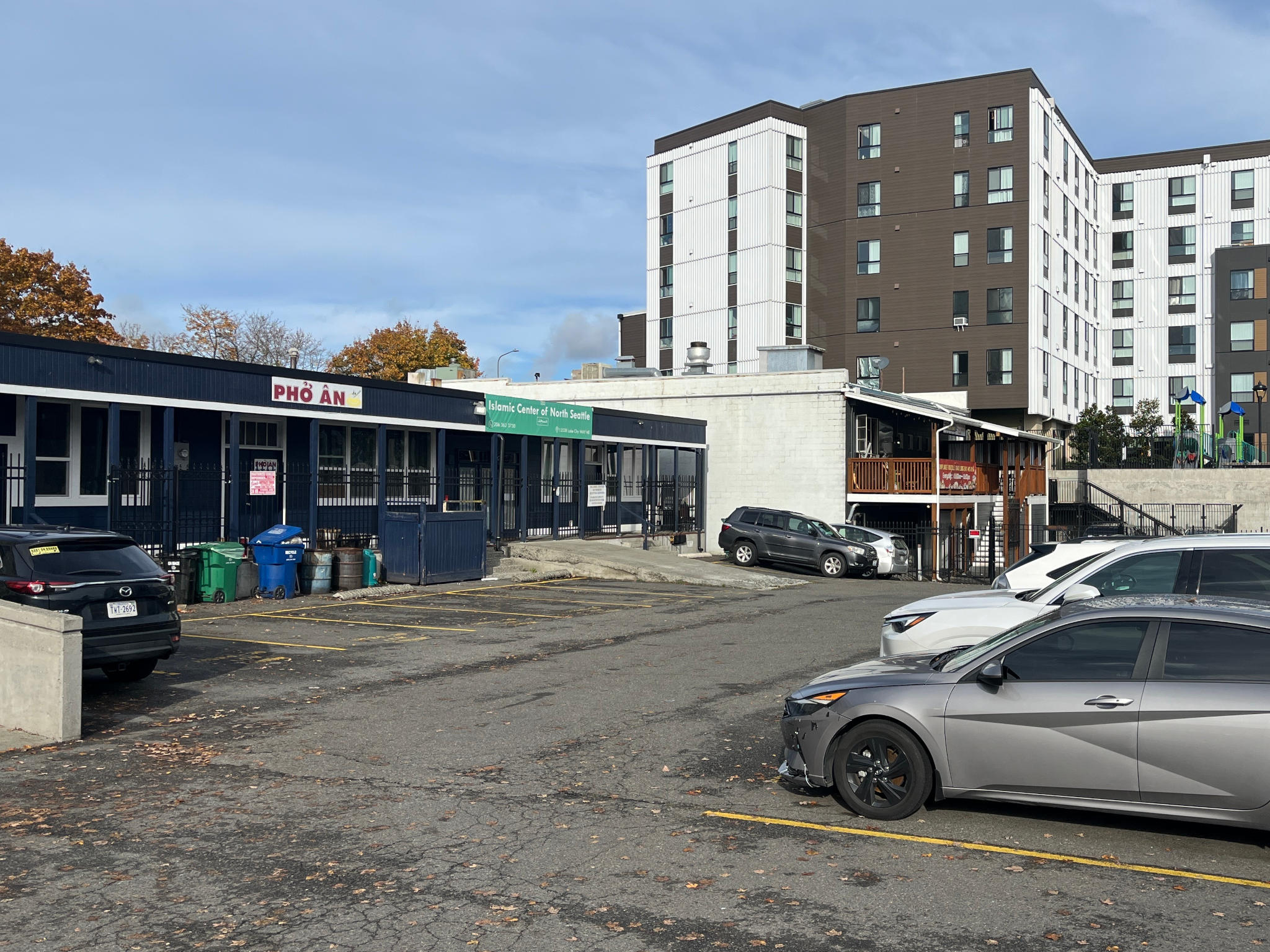 Rear parking lot with Pho An and neighboring buildings visible
